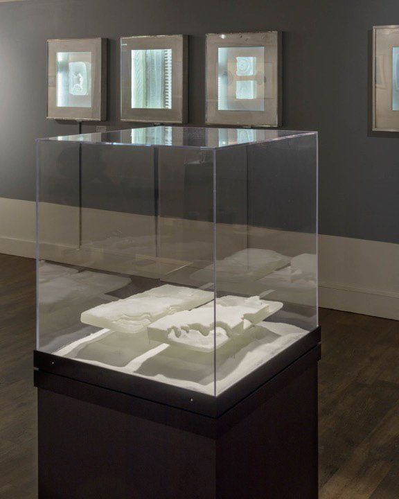 A glass display case with a white object inside of it