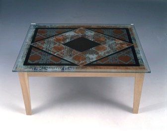 A table with a glass top and wooden legs