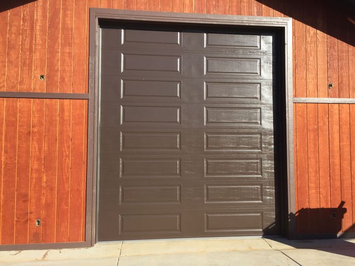 A man is installing an air conditioner on the side of a building.