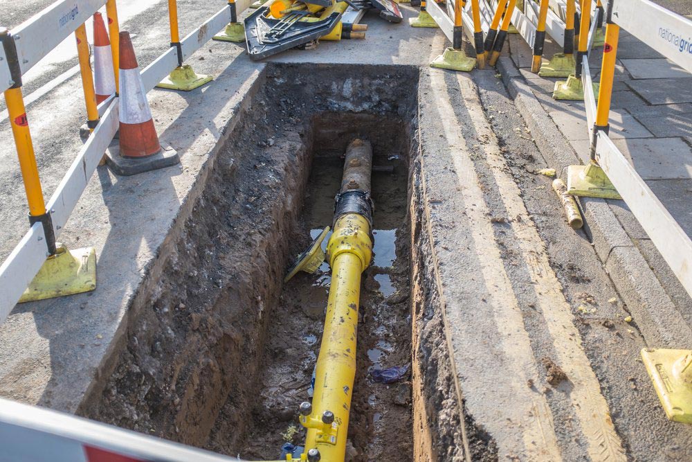 Underground Pipe Being Fixed In Trench — Dempsey Plumbing in Lake Haven