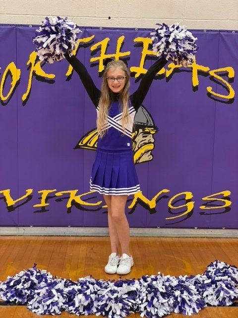 standing cheerleader forming y with arms