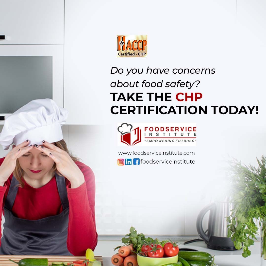 A woman in a chef 's hat is sitting in a kitchen with vegetables.