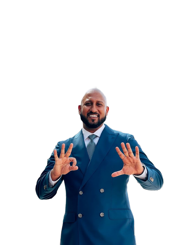 Man in blue suit, smiling, giving 