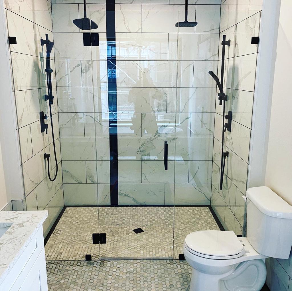 A bathroom with a walk in shower and a toilet.