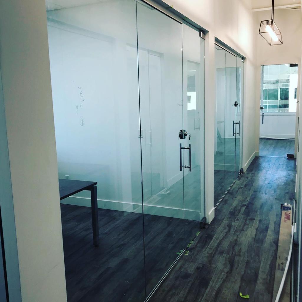 A hallway with sliding glass doors and a table