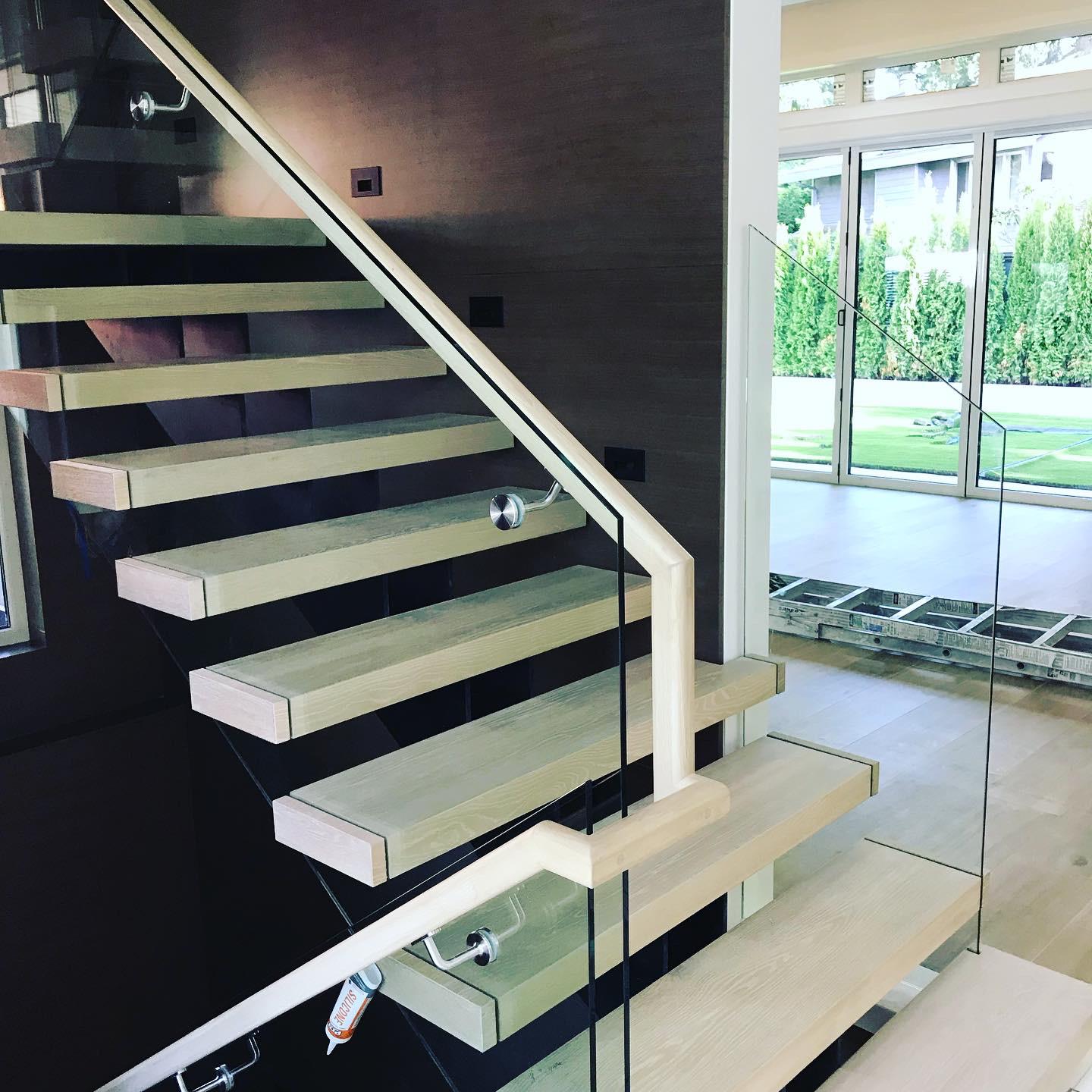 A staircase with a glass railing in a house
