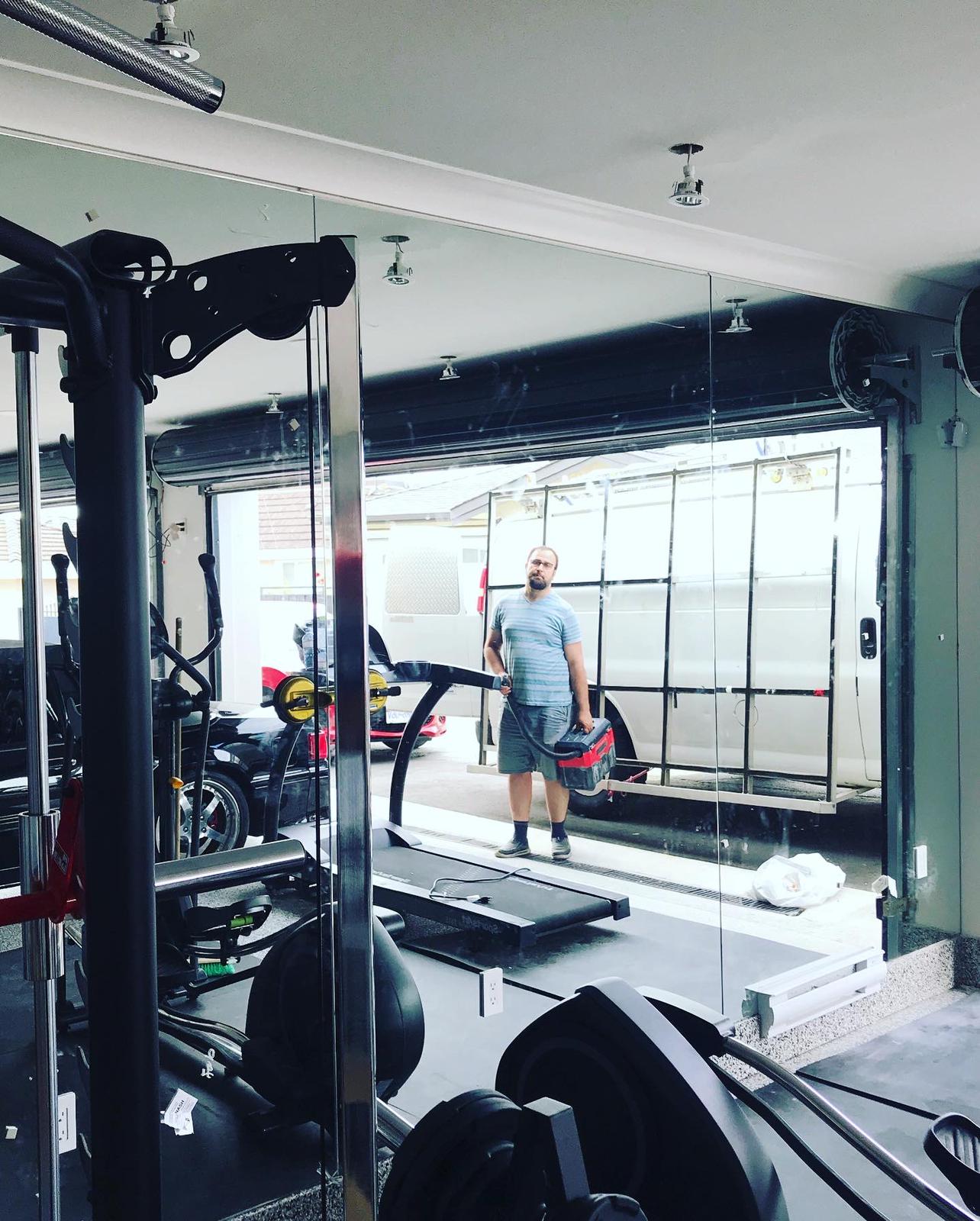 A man is running on a treadmill in a gym