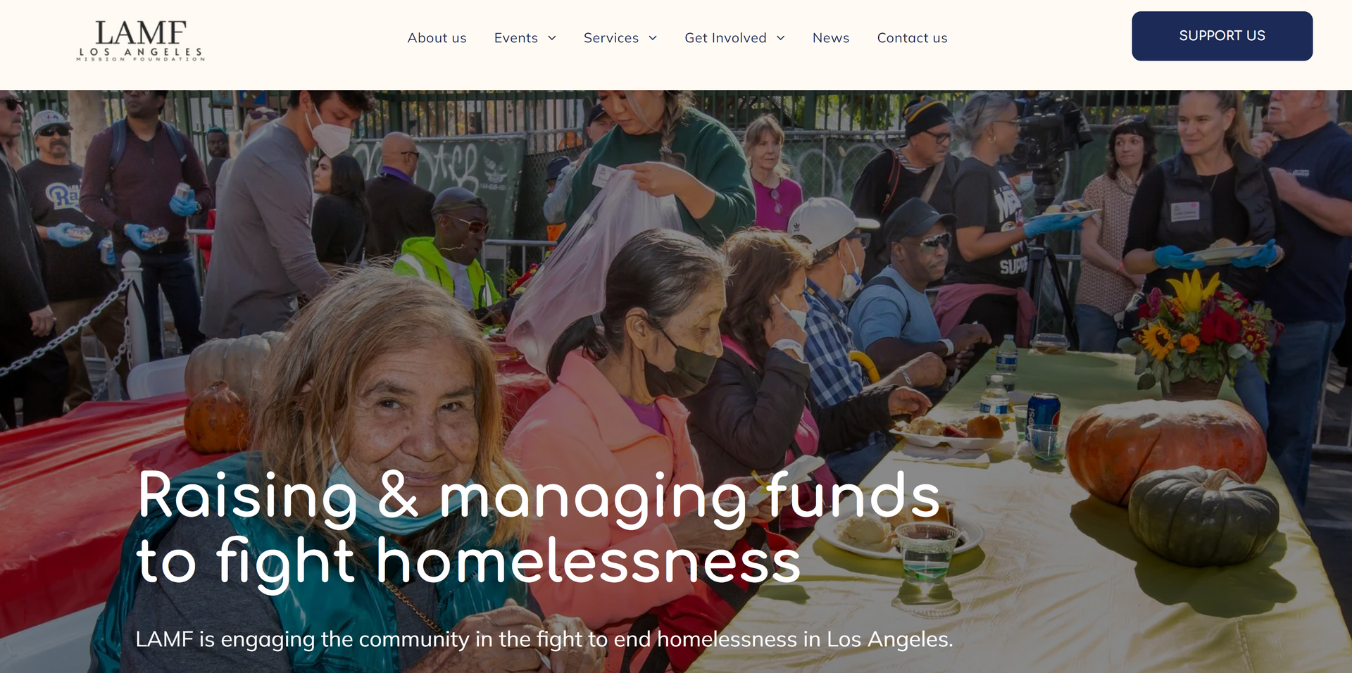 A group of people are sitting at a table with pumpkins.