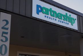Sign for Partnership Health Center, with building number