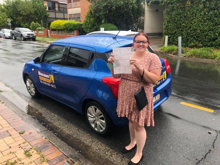 Student Driver Wearing A Dress Holding A Certificate — Driving Lessons In Ipswich, QLD