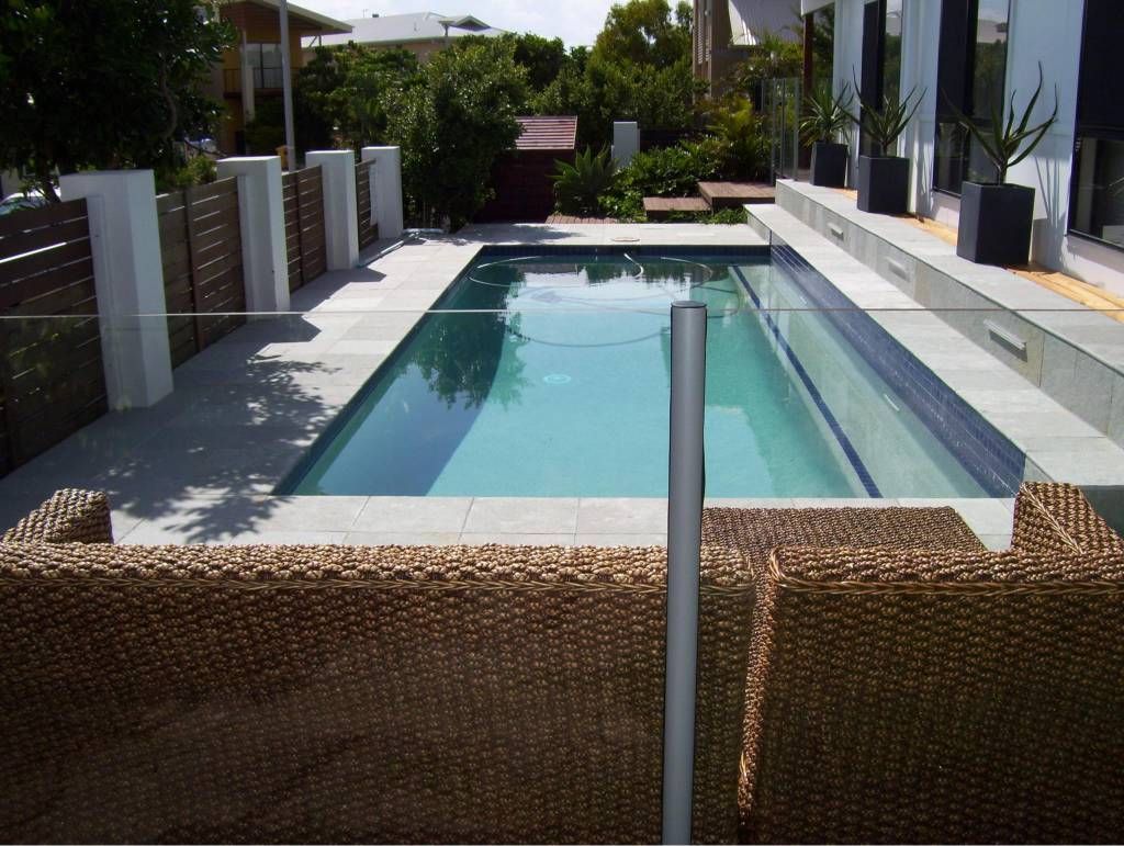 Rectangular Swimming Pool Surrounded by a Paved Patio and Wicker Fence — Banora Pools in Tweed Heads South, NSW