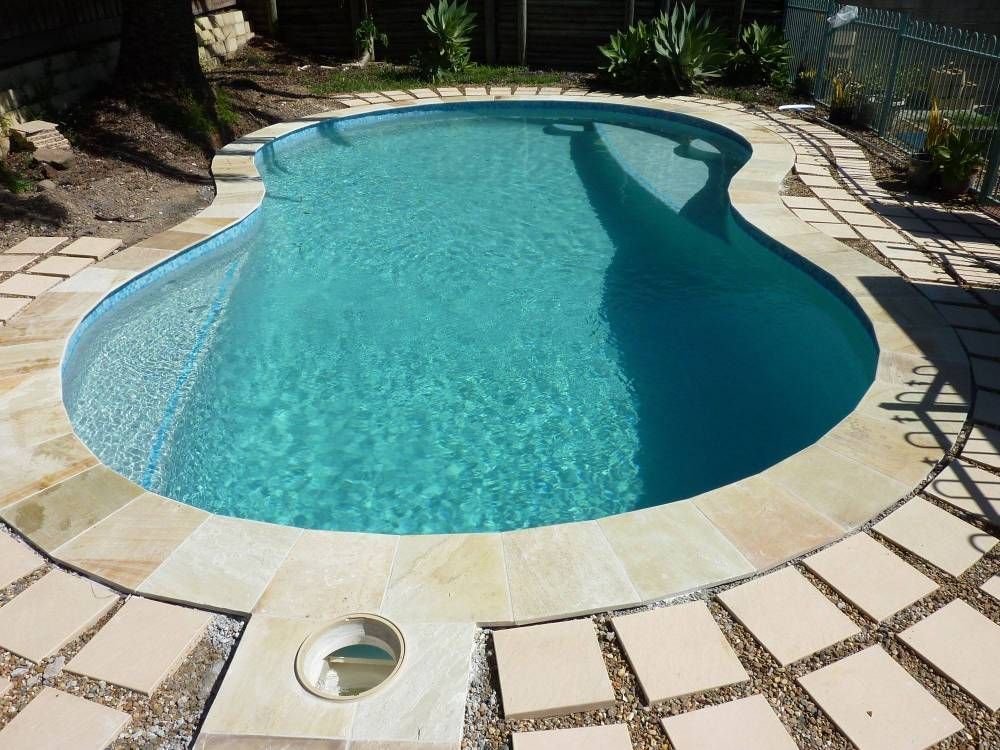 A Freeform Turquoise Pool With Stone Border and Paving Stones — Banora Pools in Byron Bay, NSW