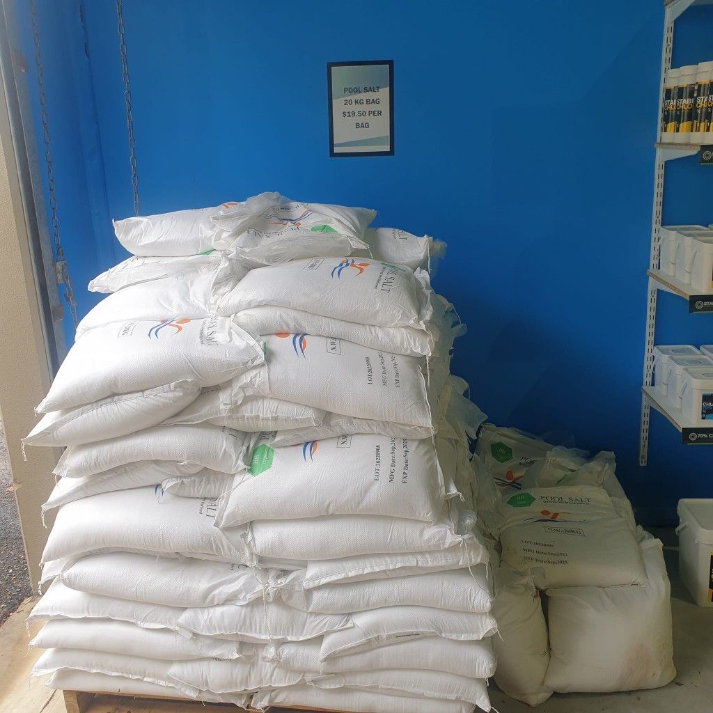 Pile of White Bags Stacked on a Pallet in Front of a Blue Wall — Banora Pools in Pottsville, NSW