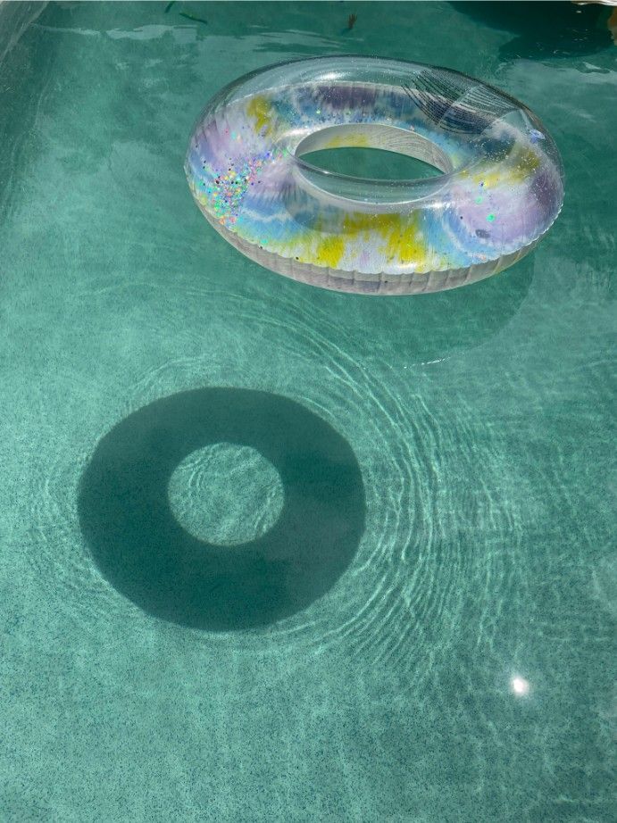 An Inflatable Pool Ring Floats in a Pool, Casting a Shadow — Banora Pools in Pottsville, NSW
