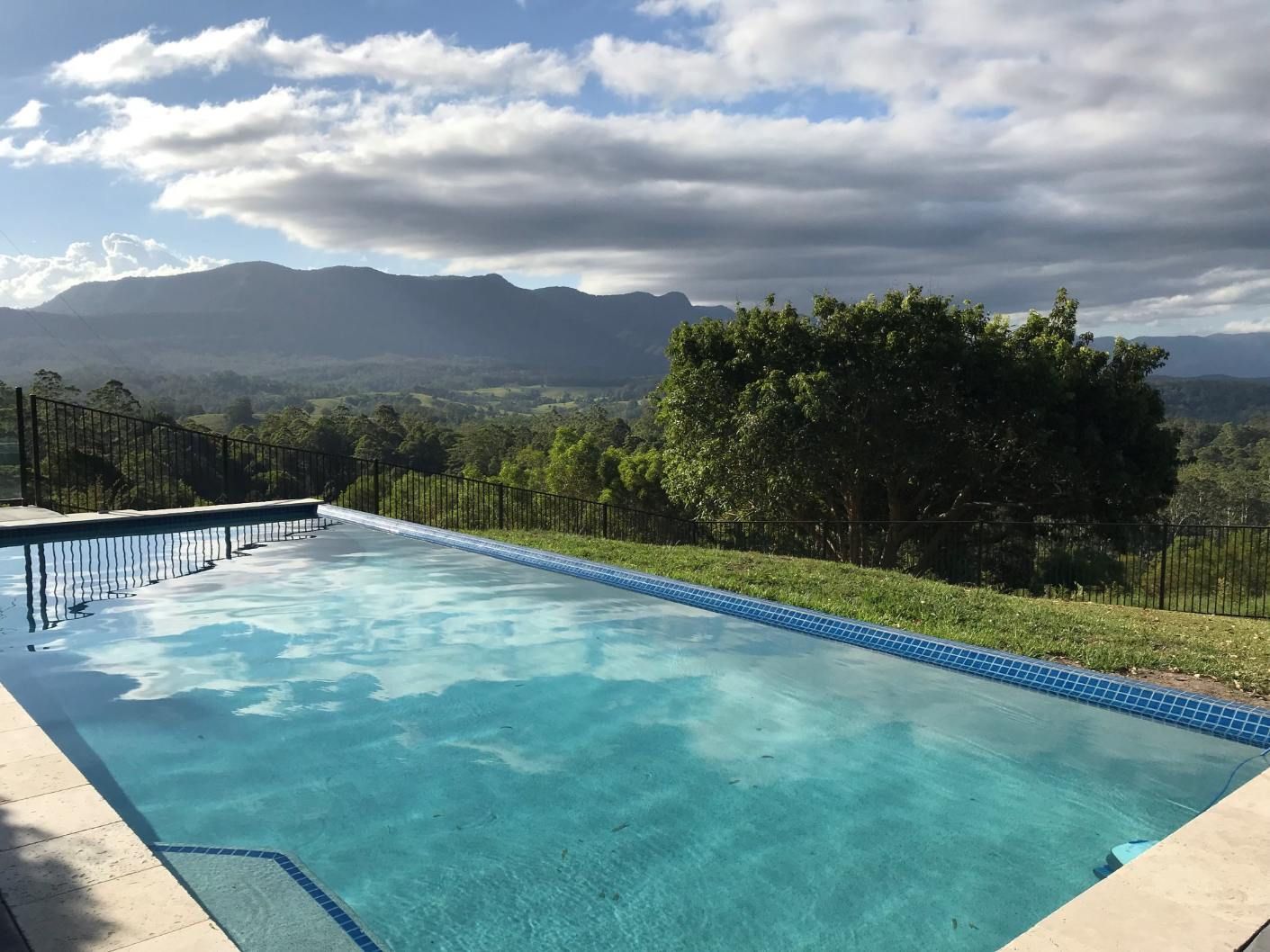 Pool Overlooking Mountains and Valley Under a Cloudy Sky — Banora Pools in Byron Bay, NSW