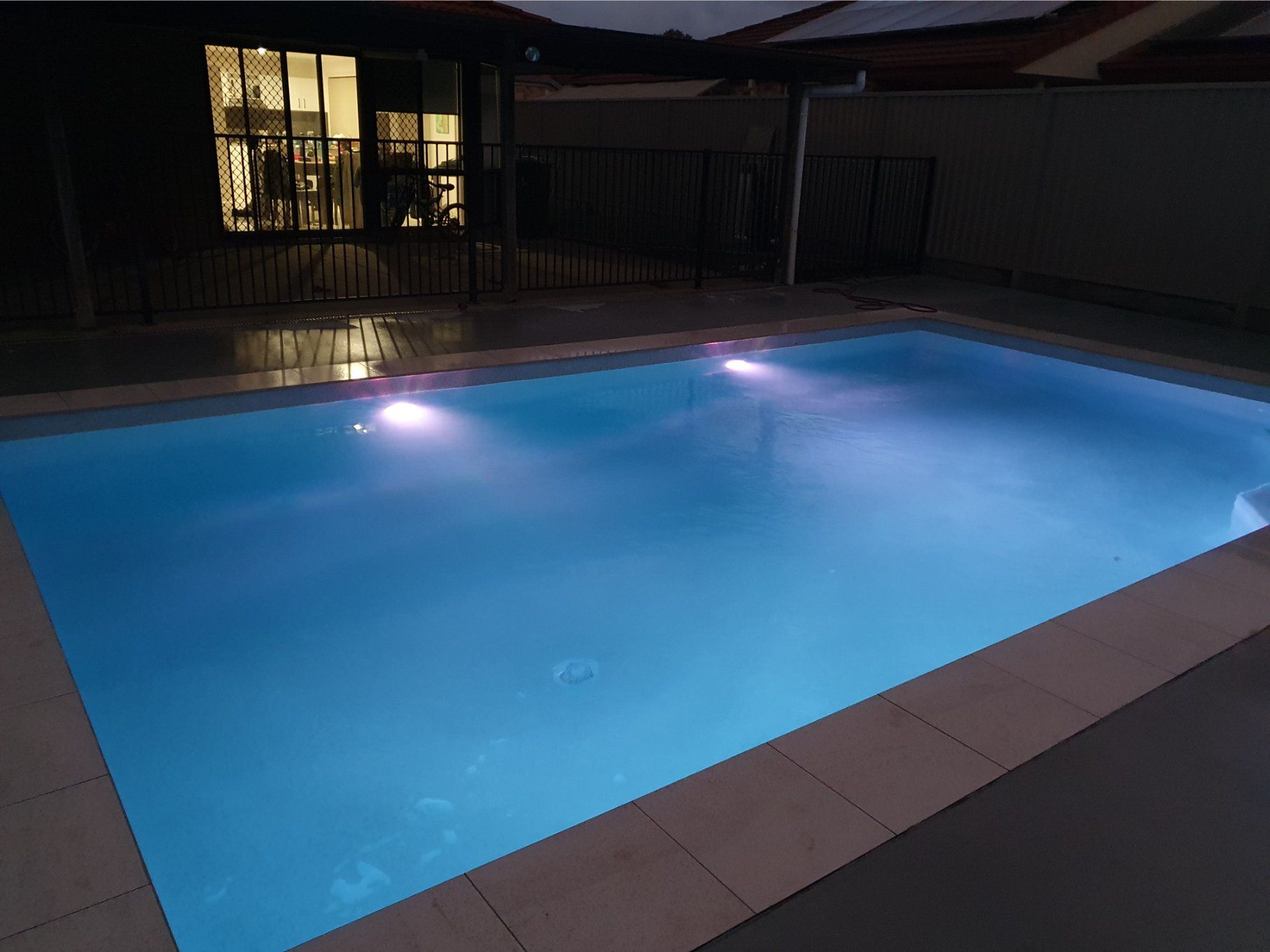 A Rectangular, Illuminated Swimming Pool at Night. Lights Reflect in the Water — Banora Pools in Pottsville, NSW