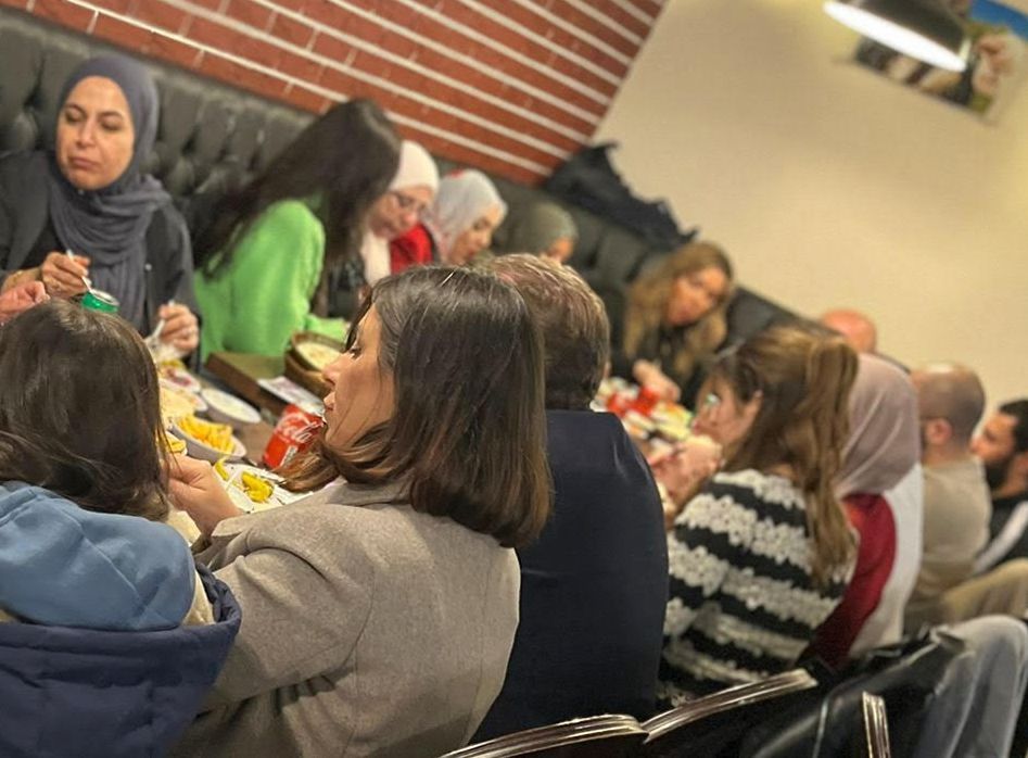 Women and families sitting eating dinner in a restaurant