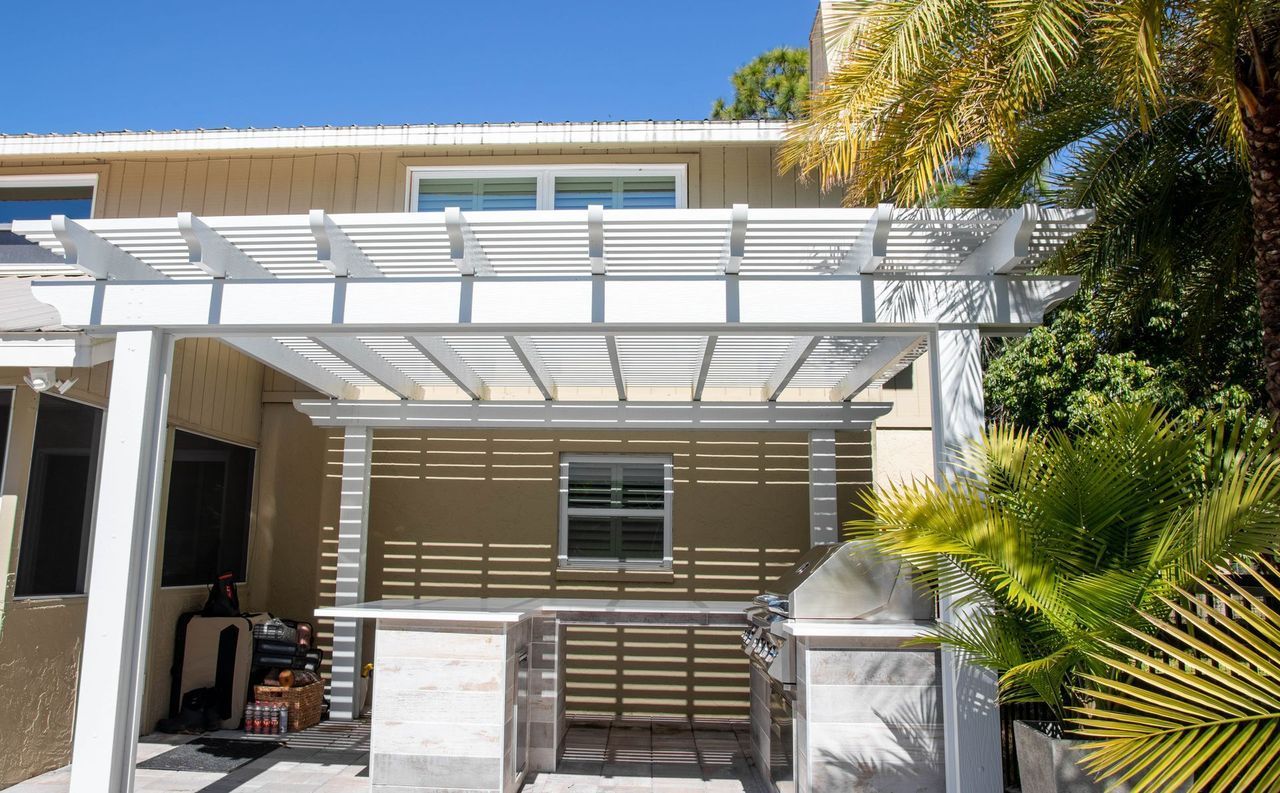white aluminum pergola with outdoor kitchen Bokeelia FL