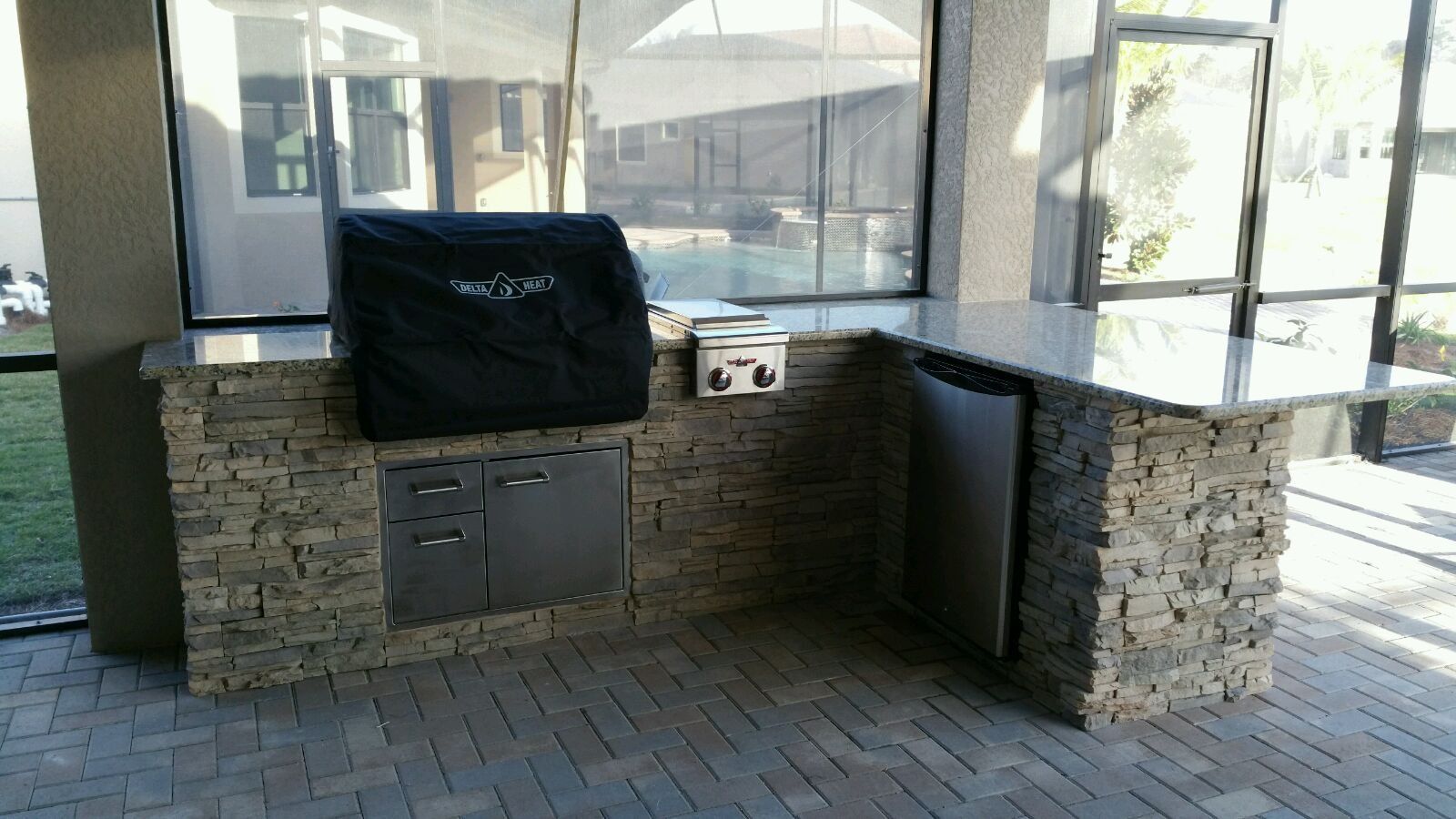 stacked stone outdoor kitchen with delta heat grill