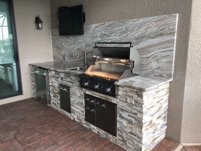 outdoor kitchen with full granite backsplash bonita springs, fl