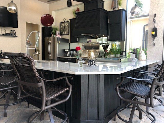 Black U shape outdoor kitchen, white granite, black cabinets, bar seating, modern, sleek, Southwest FL