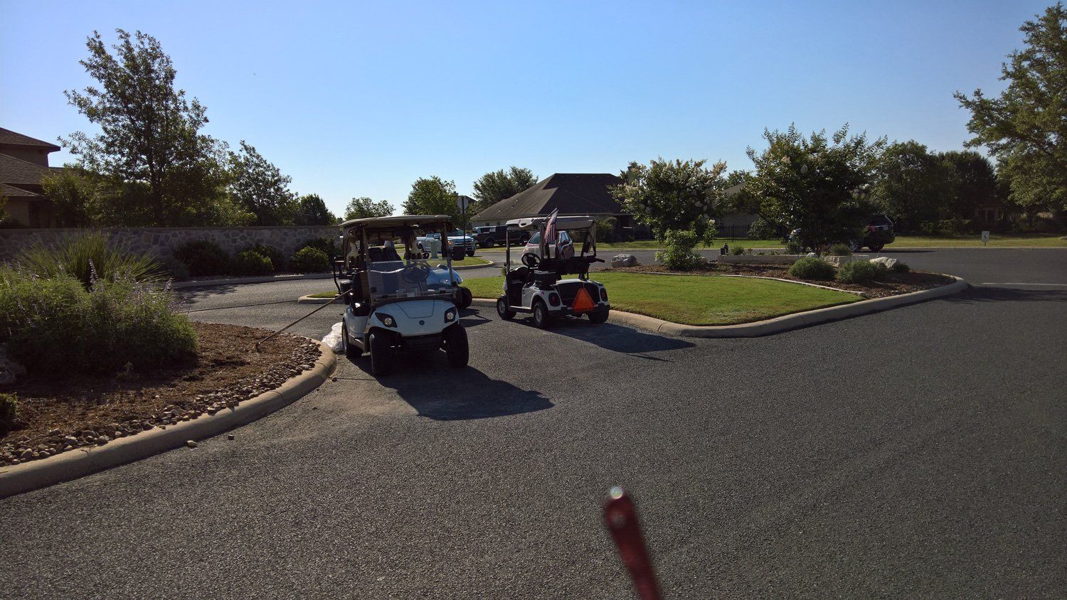 Two golf carts are parked on the side of the road