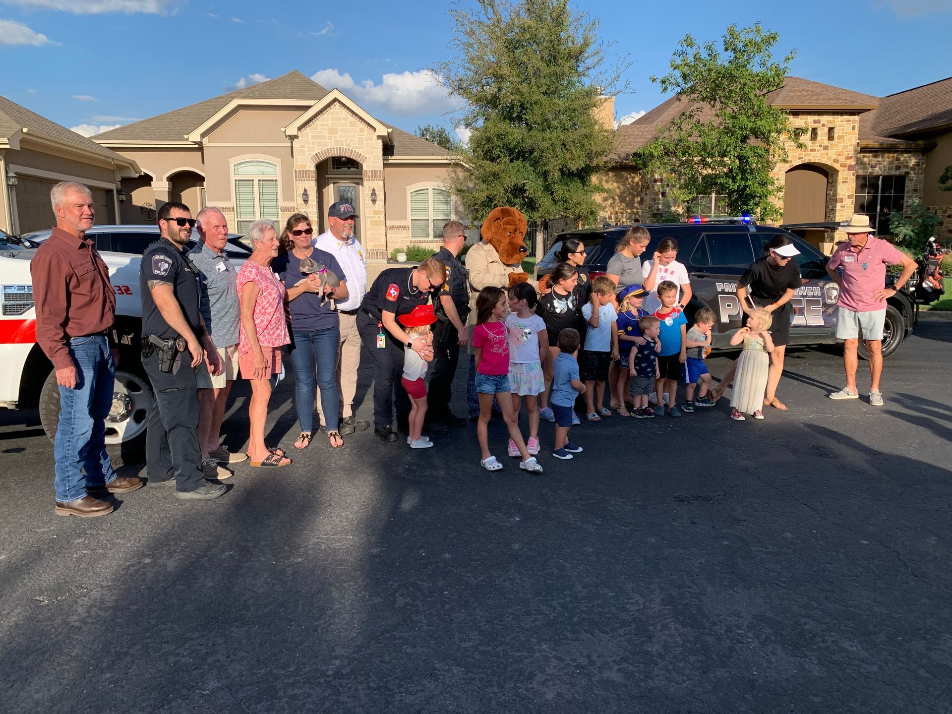 A group of people are standing in front of a house.