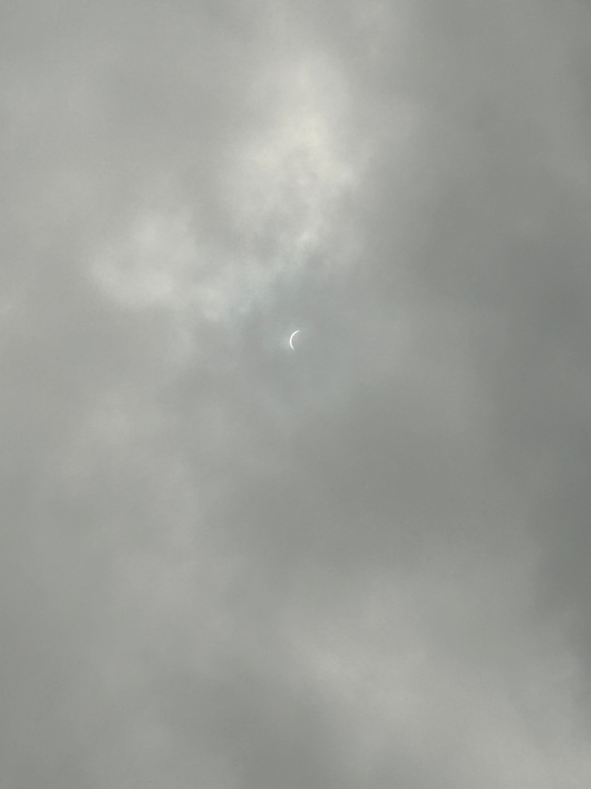The moon is visible through the clouds in the sky.