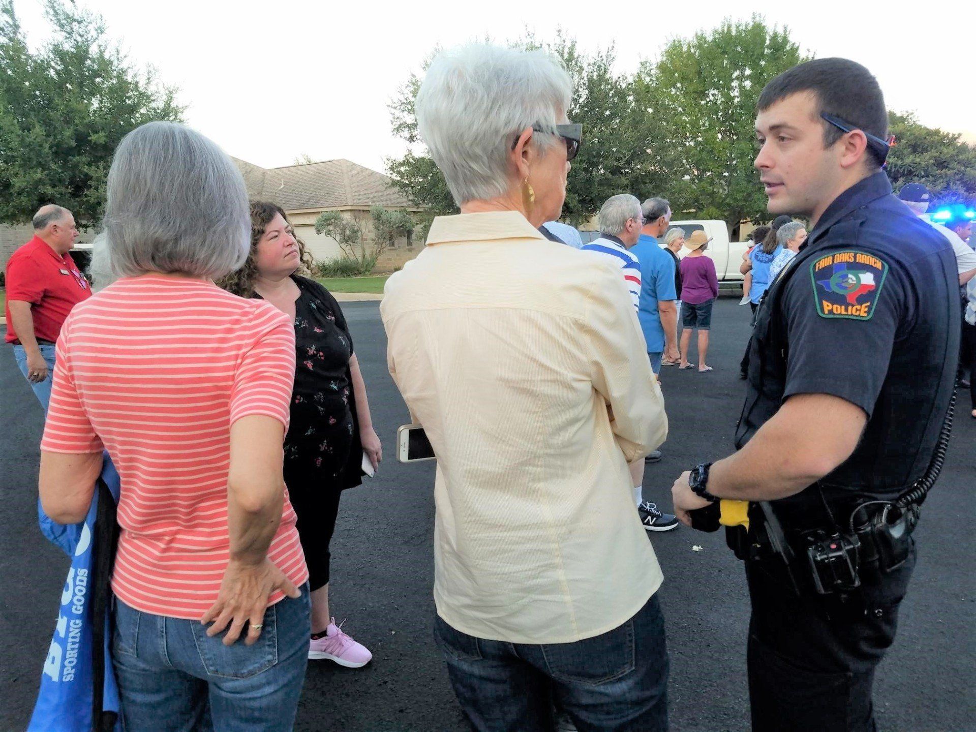 A police officer is talking to a group of people