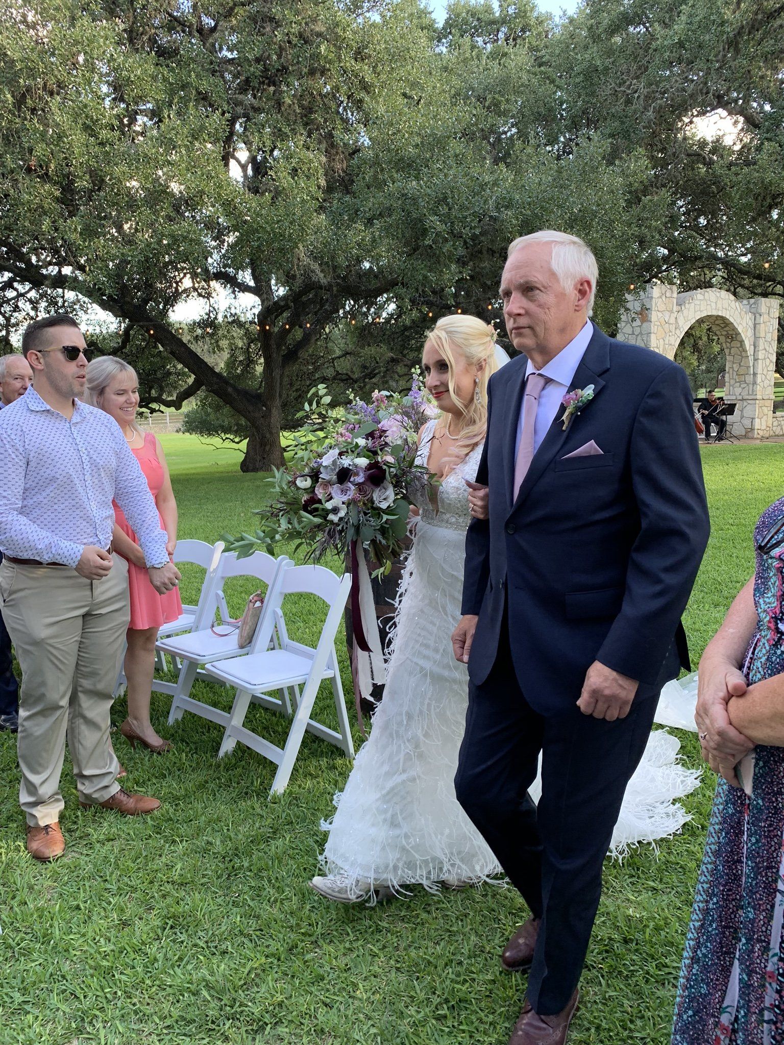 A bride and groom are walking down the aisle at their wedding.