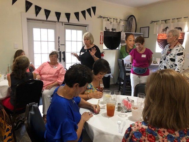 A group of women are sitting at tables in a room