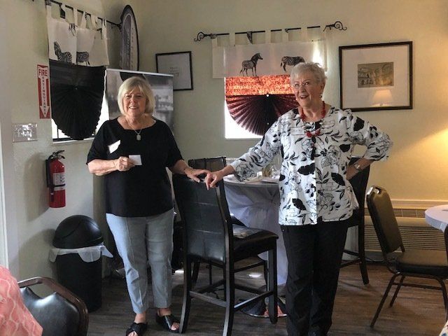 Two women standing next to each other in a room