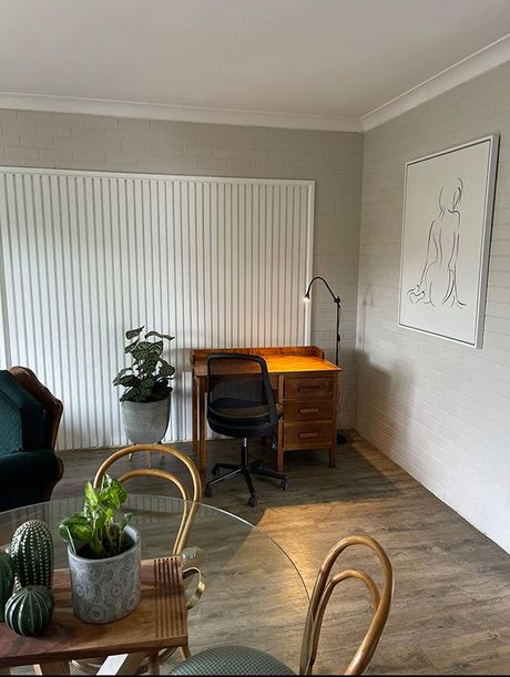 A Living Room With A Desk, Chair, Table And Plants — Country Leisure Dubbo in Dubbo, NSW