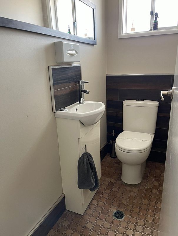 A Bathroom With A Toilet , Sink And Mirror — Country Leisure Dubbo in Dubbo, NSW