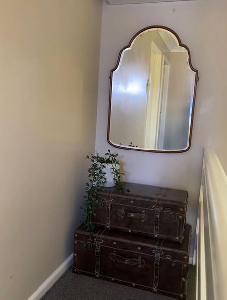 A Mirror Hangs Above A Trunk In A Hallway — Country Leisure Dubbo in Dubbo, NSW