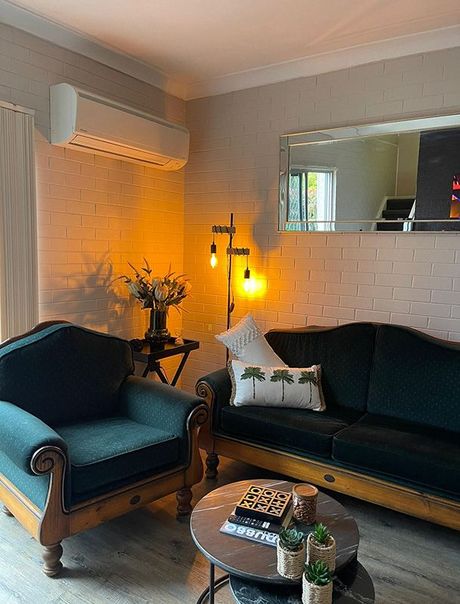 A Living Room With A Couch, Chair, Coffee Table And Mirror — Country Leisure Dubbo in Dubbo, NSW