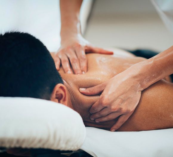 Massaging Shoulders Of A Male Athlete — 360 Muscle Therapy in Bolwarra Heights, NSW