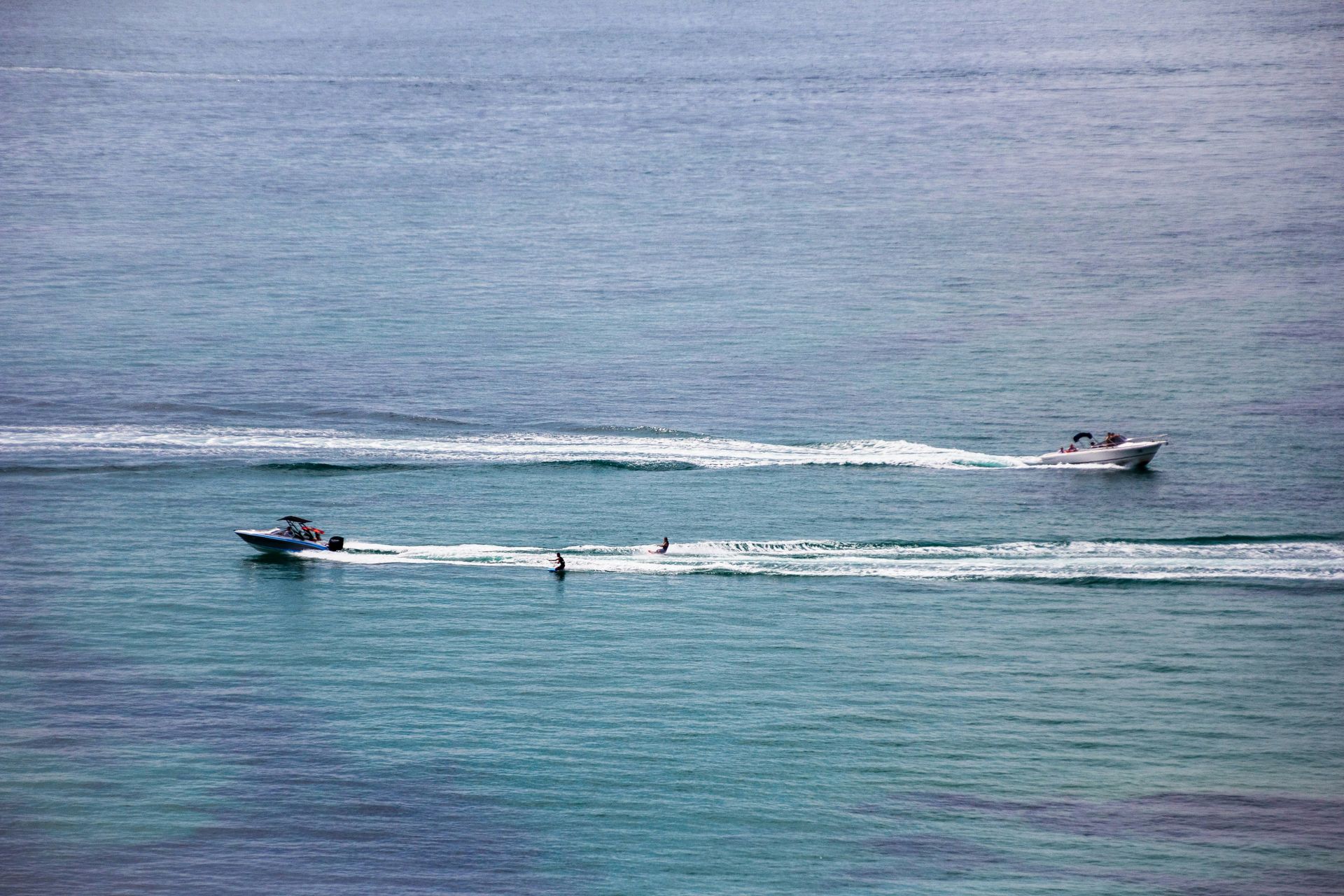 A couple of boats are floating on top of a body of water.