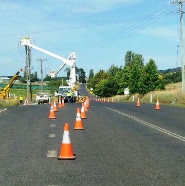 A Row Of Orange And White Traffic Cones On The Side Of A Road - NSW - Midwest Traffic Management