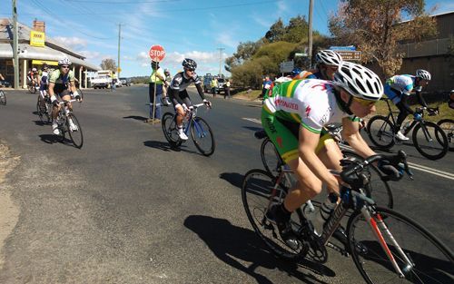 A Group Of People Are Riding Bicycles Down A Street - NSW - Midwest Traffic Management