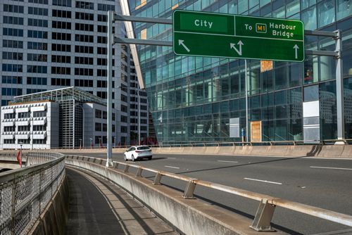 A Car Is Driving Down A Highway Next To A Sign That Says City - NSW - Midwest Traffic Management