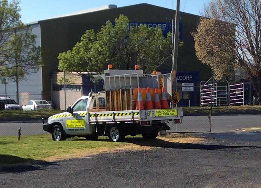 A White Truck Is Parked In Front Of A Building That Says Net Corp - NSW - Midwest Traffic Management