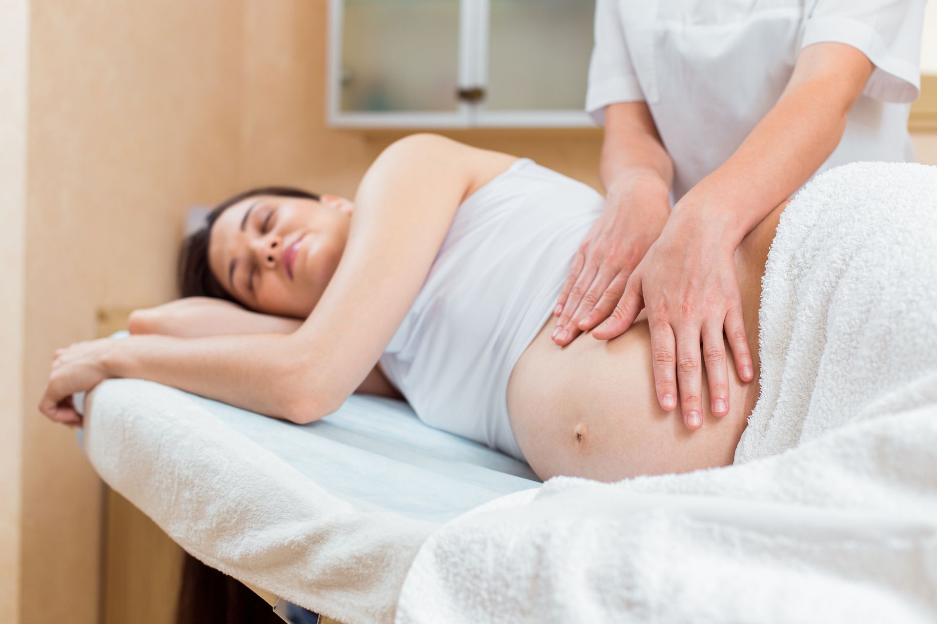 A pregnant woman is getting a massage.