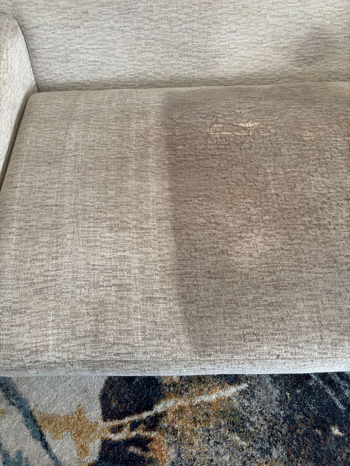 A sofa cushion shows a distinct cleaning difference: one side is clean, the other is dirty.