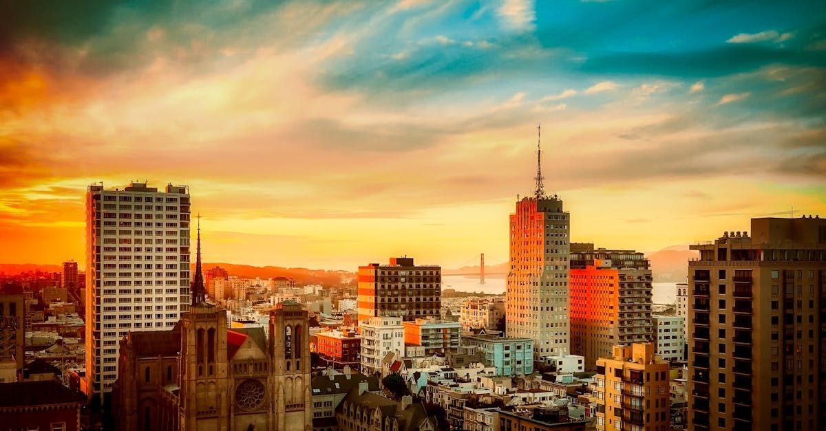 An aerial view of a city skyline at sunset.