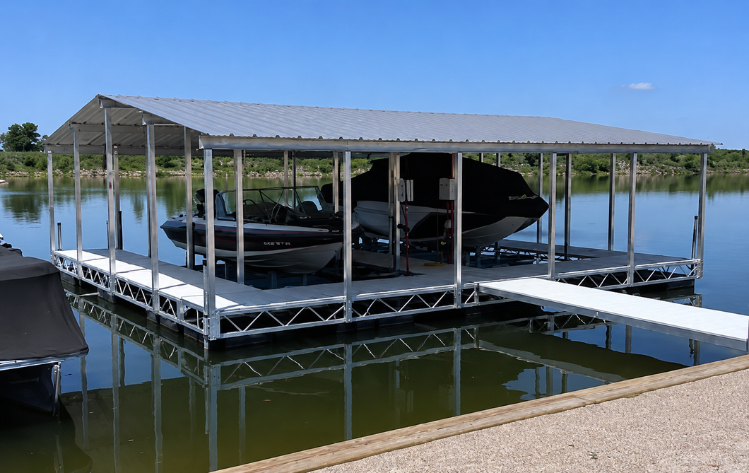 Contact Rockingham Marina Today! Boat being loaded onto a dockside lift at sunset by workers near a lake