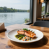 Grilled salmon with asparagus and rice on a white plate by a lake-view window