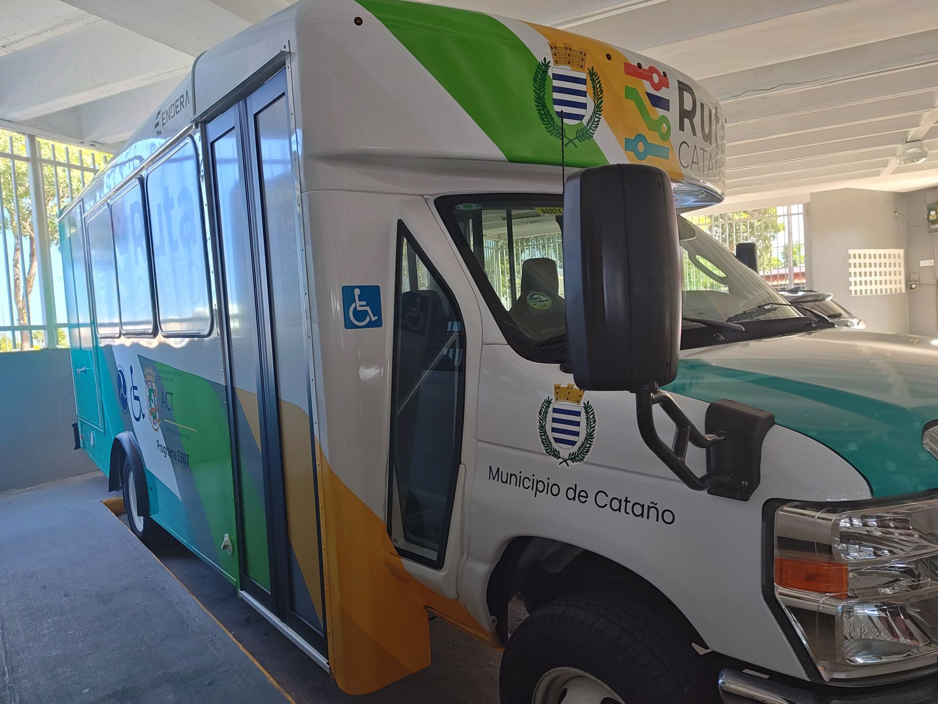 Passenger loading his bicycle on the front of bus
