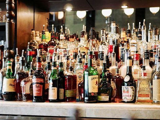 A bar filled with lots of bottles of liquor.