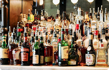 A bar filled with lots of bottles of liquor.